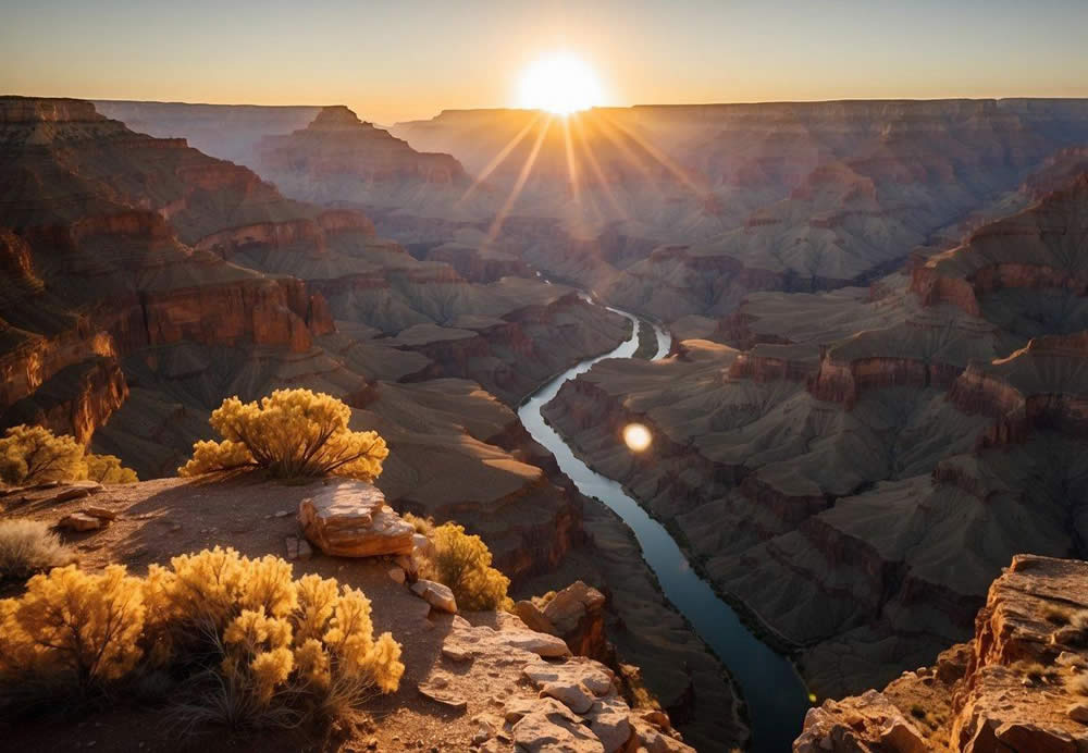 The sun sets over the vast expanse of the Grand Canyon, casting a warm glow on the rugged cliffs and deep crevices. The Colorado River winds its way through the canyon, reflecting the golden light